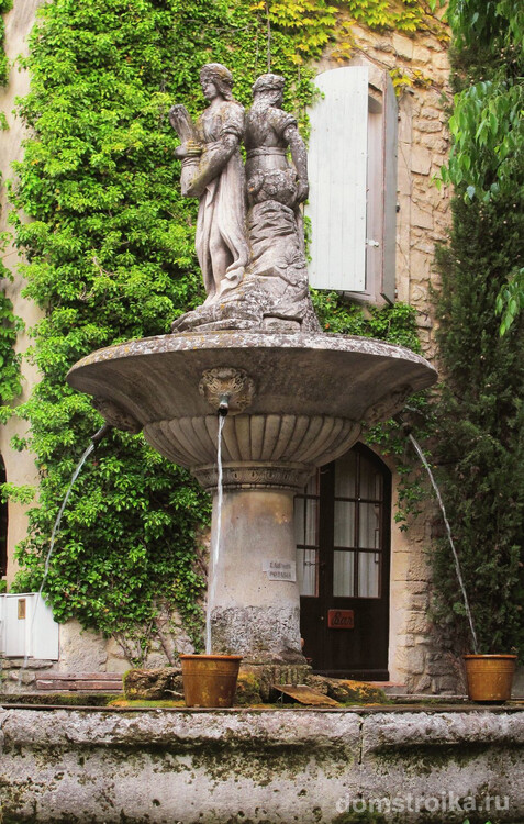 Скульптуры на фонтане в классическом саду