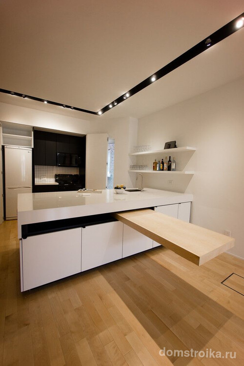 Выдвижной стол из кухонного острова на кухне в стиле минимализм