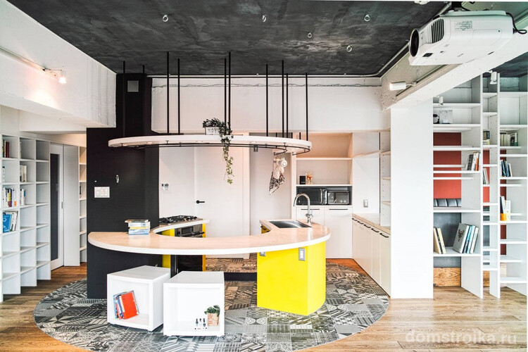 Черно-белая напольная плитка, стыкованная с ламинатом для четкого зонирования пространства, и эксклюзивный радиальный кухонный гарнитур