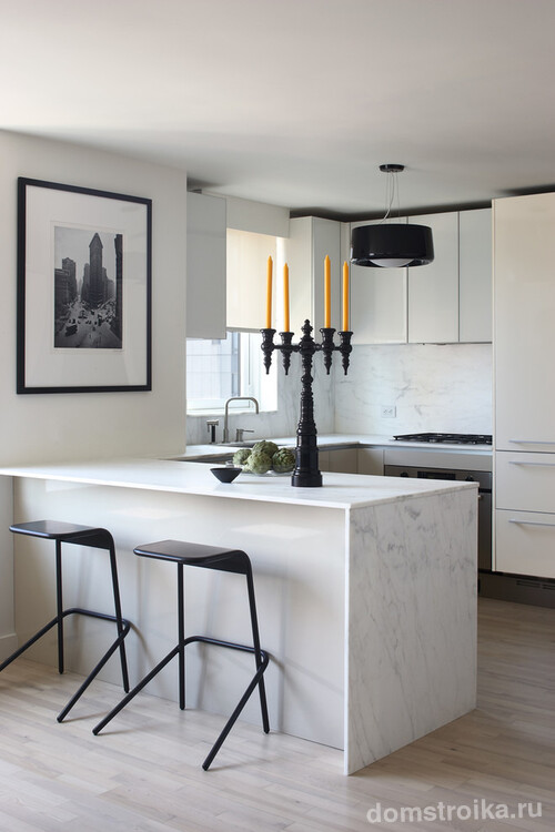 Современная кухня с преобладанием белого цвета разбавленного черными элементами. Прожилки мрамора и черно-белые фото в качестве декора дополняют картину