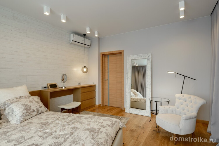 Белый ламинат на одной из стен хорошо смотрится со светло-коричневым ламинатом на полуспальни