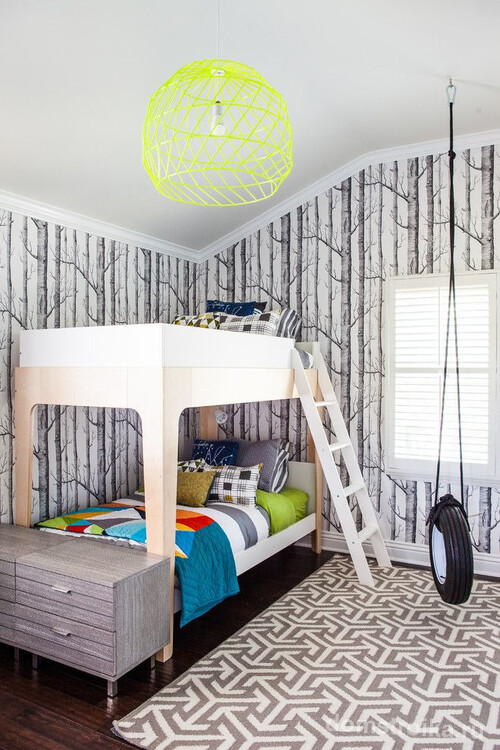 Современный интерьер детской спальни: графические фотообои, экономящая пространство двухъярусная кровать, яркая каркасная люстра, оригинальное решение качели